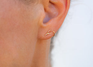 14k gold seaweed stud earrings on ear