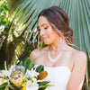 island bride with white fitted dress and white shell jewelry