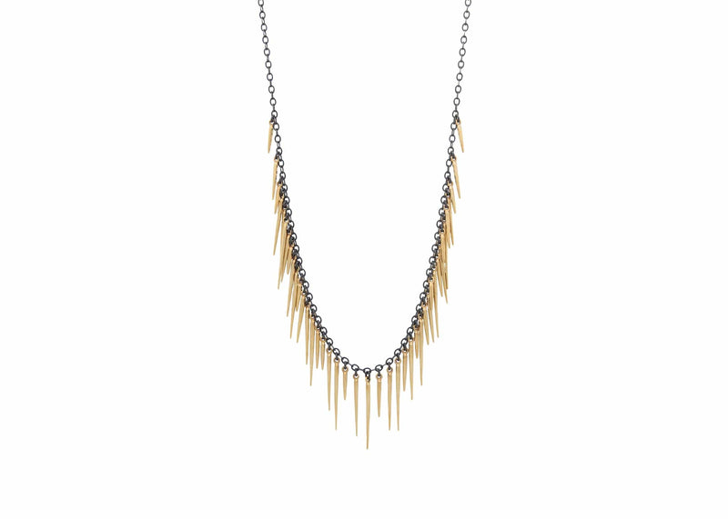 fringe necklace and bracelet with gold urchin spines and black chain on model