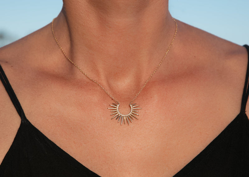 spiky 14k gold urchin necklace with pave set diamonds on model