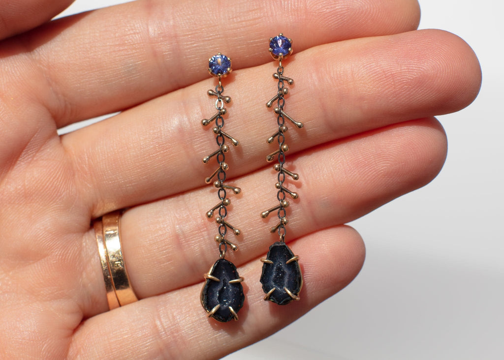 dangly earrings with black tabasco geodes gold barbells and purple sapphires