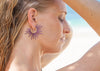 purple powder coated sea urchin spine hoop earrings on model