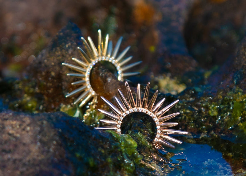 spiky gold urchin earrings with pave set diamonds on rocks with algae
