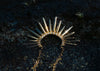 spiky gold necklace with pave set diamonds in tidepool in lava rock