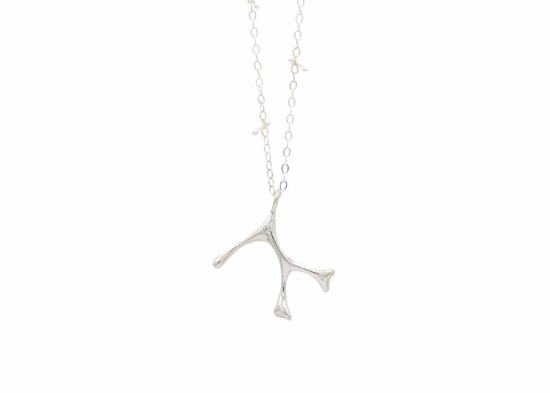 sterling silver seaweed necklace with diamonds and barbell details in chain