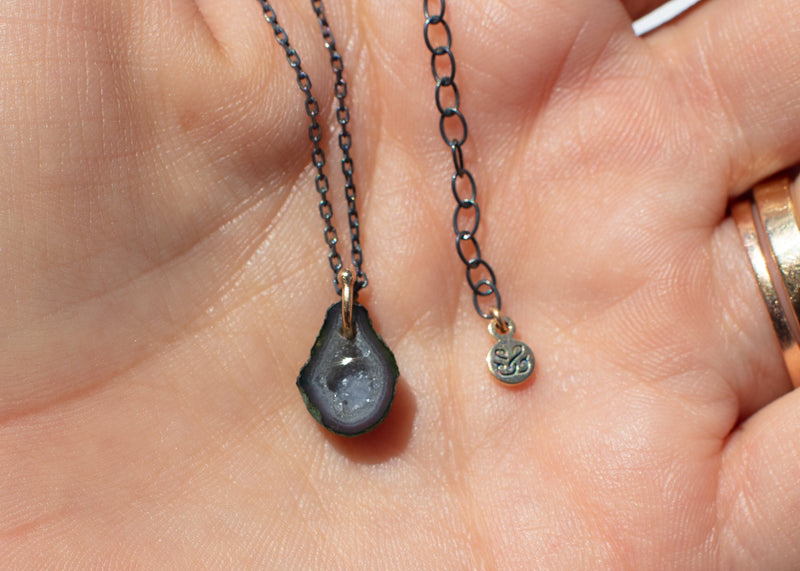 gray pear shaped tabasco geode necklace  with oxidized silver chain in hand